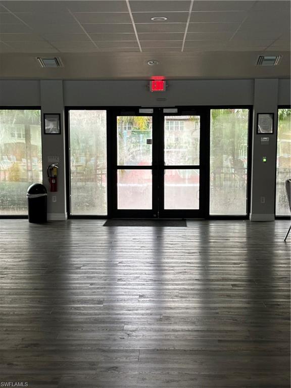4180 Looking Glass Lane, Unit 4104 Naples, FL 34112 - Photo 27 of 30 a view of an empty room with wooden floor and a window