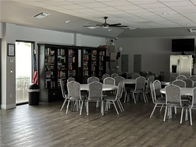 a view of an empty room with wooden floor and windows