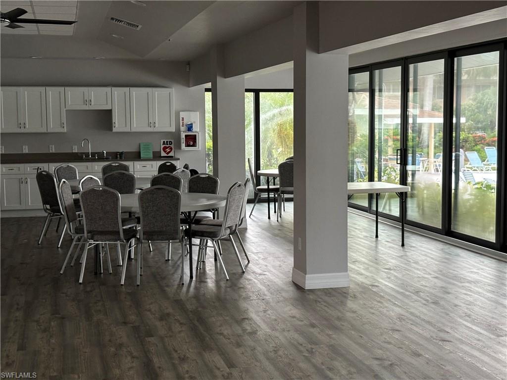 4180 Looking Glass Lane, Unit 4104 Naples, FL 34112 - Photo 29 of 30 a view of a dining room with furniture and wooden floor