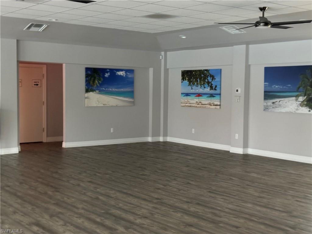 4180 Looking Glass Lane, Unit 4104 Naples, FL 34112 - Photo 30 of 30 a view of an empty room with wooden floor and windows