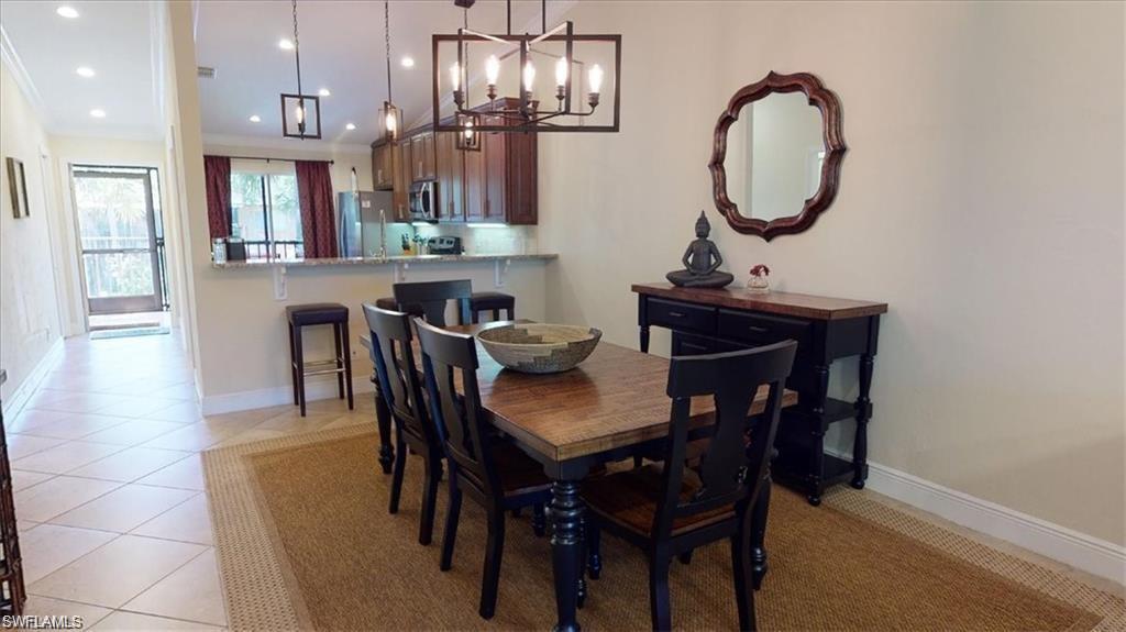 4180 Looking Glass Lane, Unit 4104 Naples, FL 34112 - Photo 9 of 30 a view of a dining room with furniture