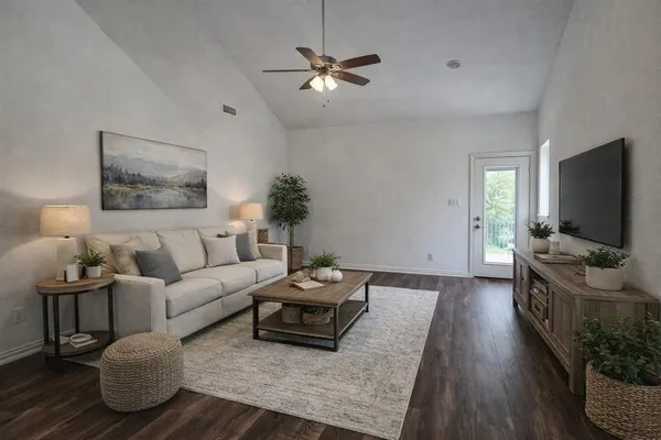 a living room with furniture and a flat screen tv