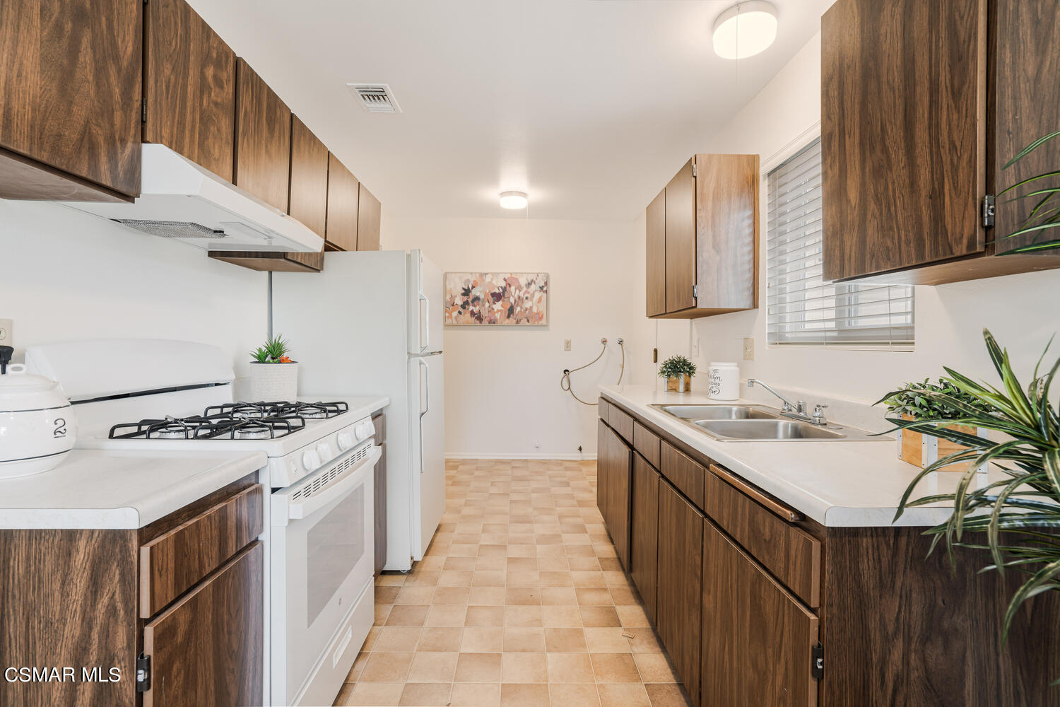 1753 Moreno Drive Simi Valley, CA 93063 - Photo 9 of 19 a kitchen with a sink stove and cabinets