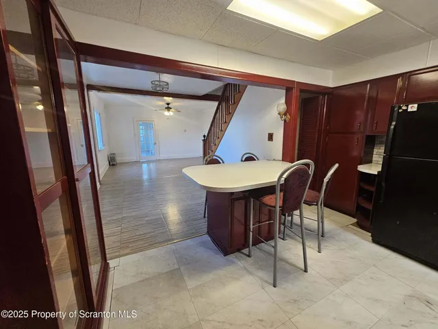 a view of a dining room with furniture and a potted plant