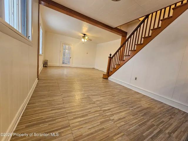 a view of an entryway with wooden floor