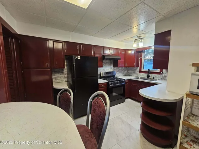 a kitchen with stainless steel appliances a refrigerator and a sink
