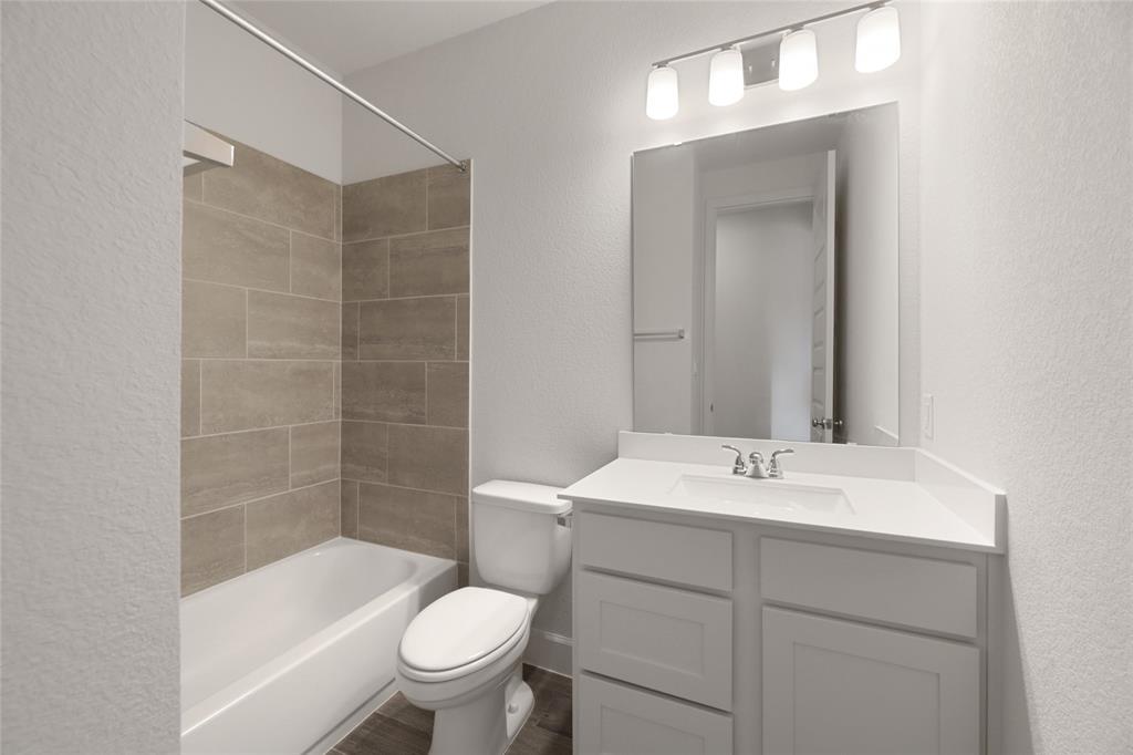 123 Plumbago Loop Bastrop, TX 78602 - Photo 17 of 40 a bathroom with a sink a toilet and shower