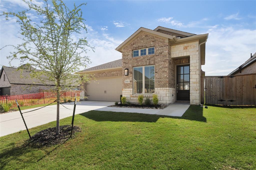 123 Plumbago Loop Bastrop, TX 78602 - Photo 2 of 40 a front view of a house with garden