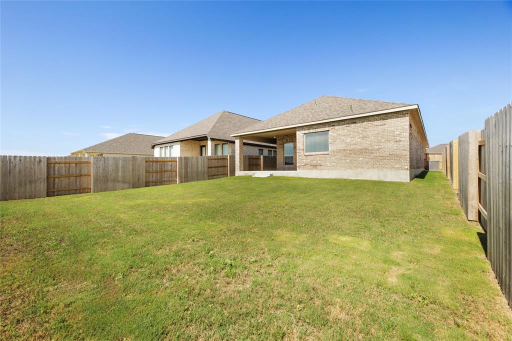 123 Plumbago Loop Bastrop, TX 78602 - Photo 22 of 40 a front view of a house with a yard