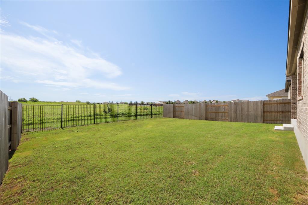 123 Plumbago Loop Bastrop, TX 78602 - Photo 23 of 40 a view of a field with an trees in the background