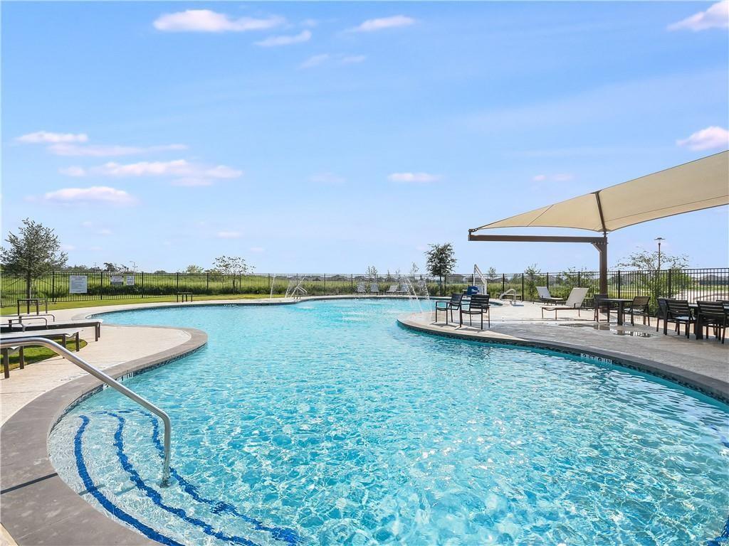 123 Plumbago Loop Bastrop, TX 78602 - Photo 29 of 40 a view of a swimming pool and lake from a seating area