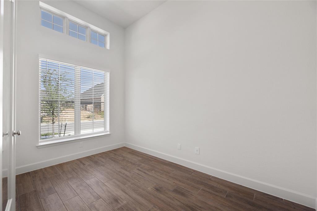 123 Plumbago Loop Bastrop, TX 78602 - Photo 5 of 40 an empty room with wooden floor and windows