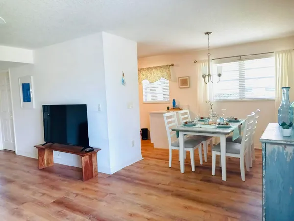 a view of a dining room with furniture and wooden floor