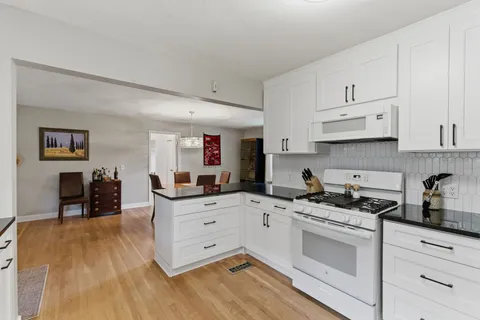 a kitchen with granite countertop a sink and cabinets
