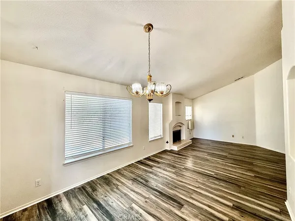 a view of a room with window ceiling fan and wooden floor