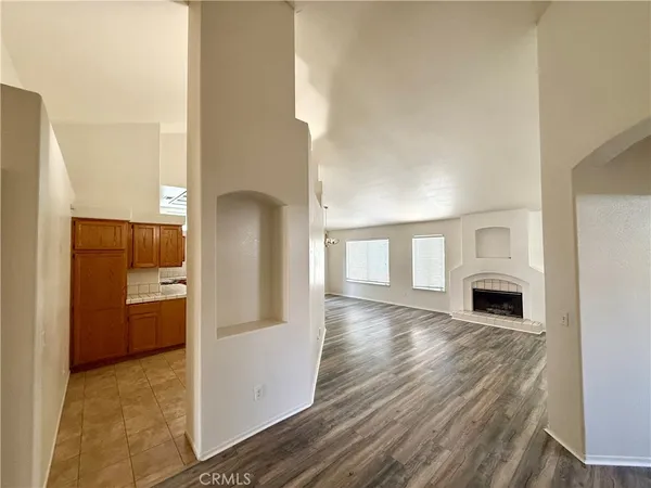 a view of living room with a fireplace and wooden floor
