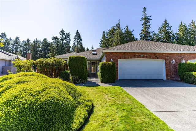 a view of an house with backyard and trees