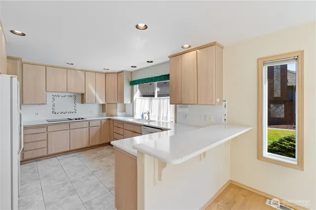 a kitchen that has a sink and a stove in it