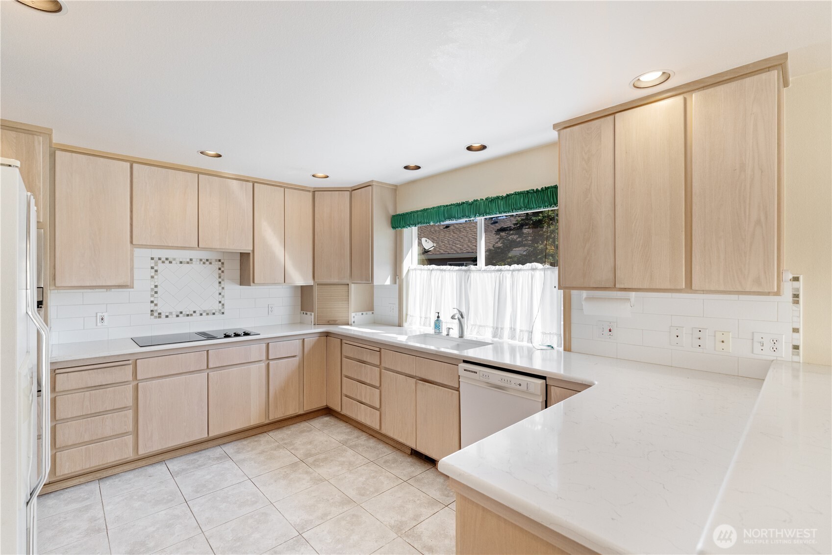 292 Foursome Drive Sequim, WA 98382 - Photo 15 of 32 a kitchen with a sink and cabinets