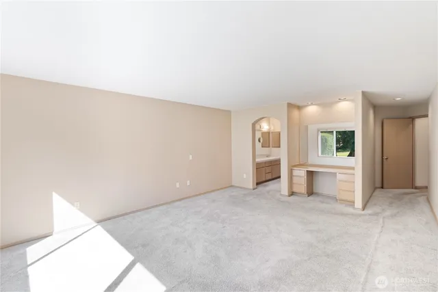 an empty room with entrance and stairs