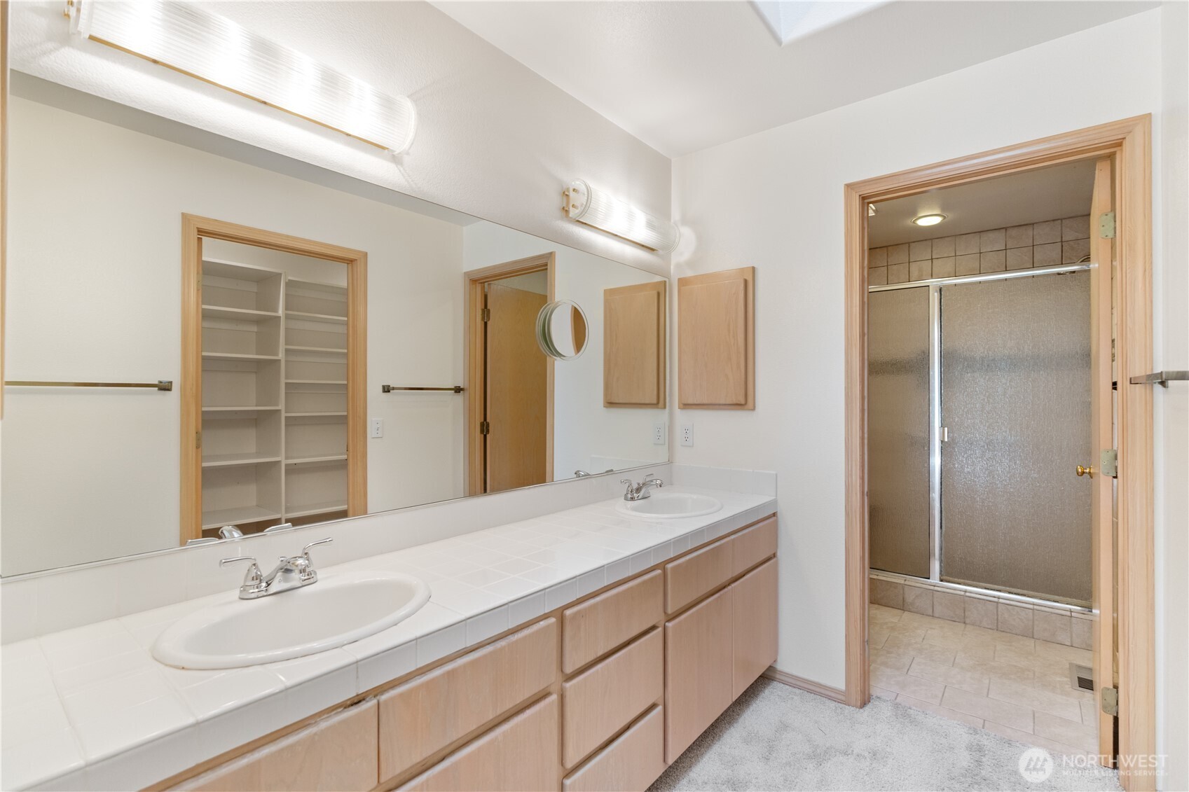 292 Foursome Drive Sequim, WA 98382 - Photo 20 of 32 a bathroom with a double vanity sink and a mirror