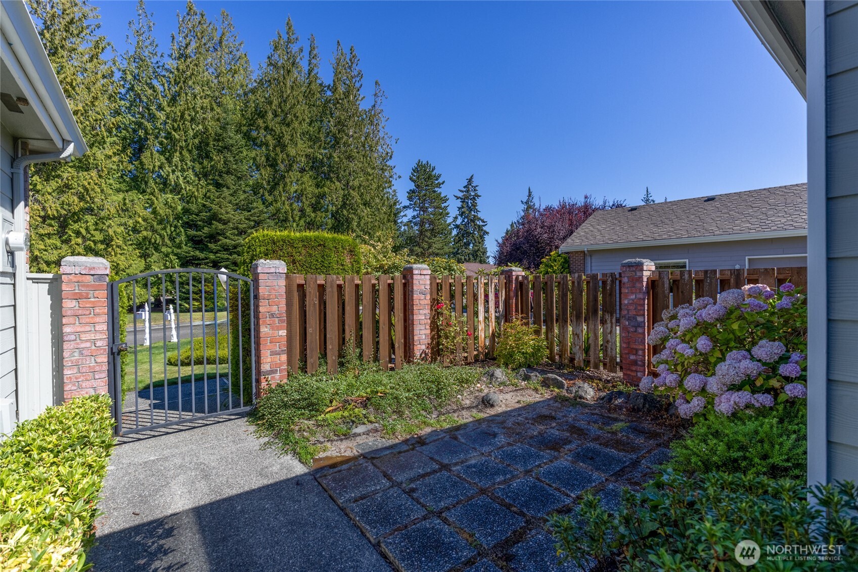 292 Foursome Drive Sequim, WA 98382 - Photo 2 of 32 a view of a garden with wooden fence