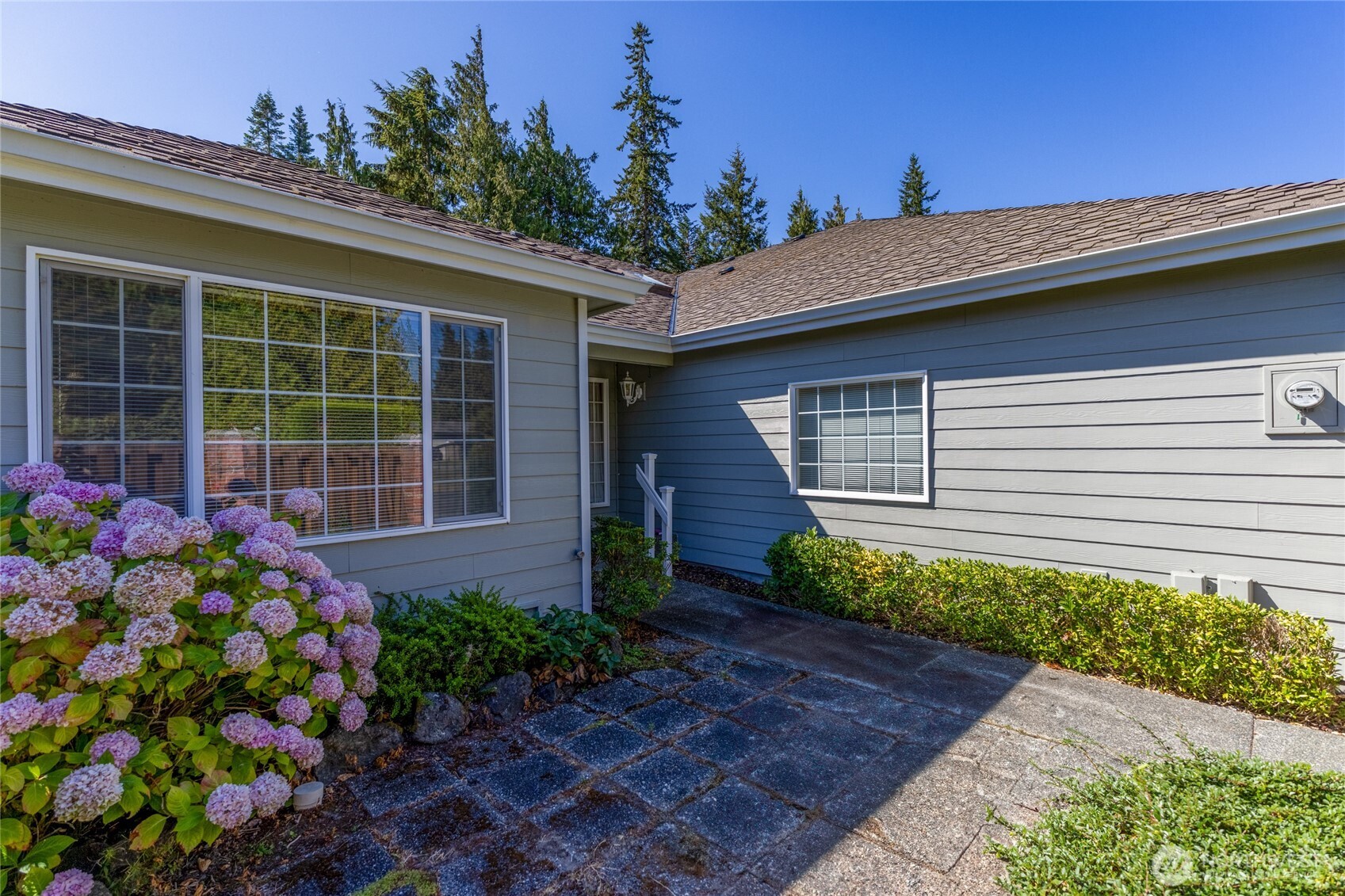 292 Foursome Drive Sequim, WA 98382 - Photo 4 of 32 a front view of a house with garden