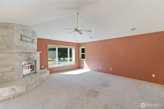 a view of a livingroom with a ceiling fan and window