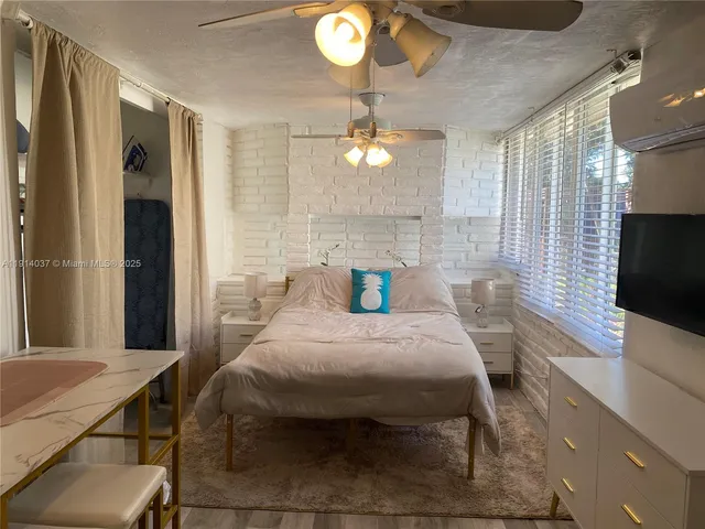 a bedroom with bed and a chandelier