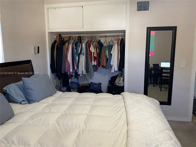 a bed room with a bed and a mirror