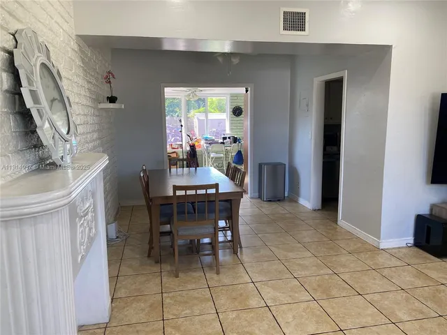 a dining room with furniture and a chandelier