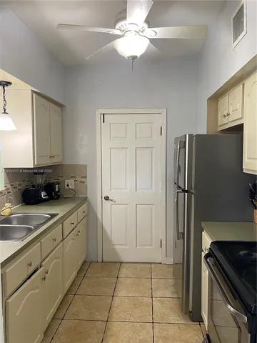 a kitchen with a refrigerator and a sink