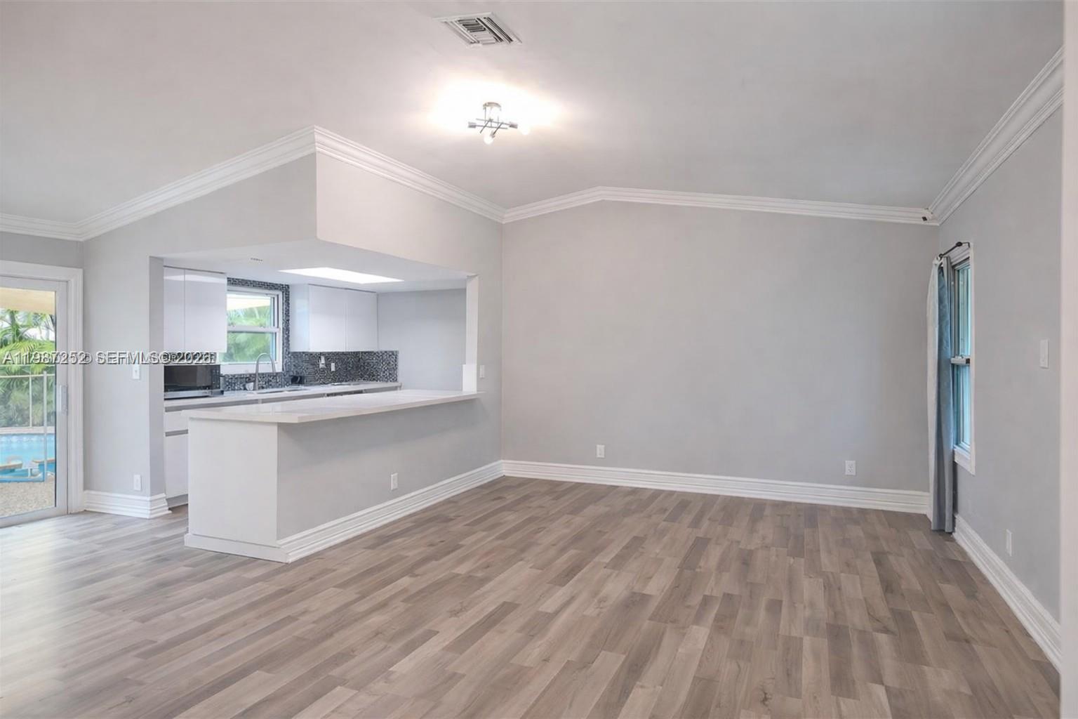 4541 Southwest 28th Terrace Dania Beach, FL 33312 - Photo 2 of 9 a kitchen with a refrigerator and window