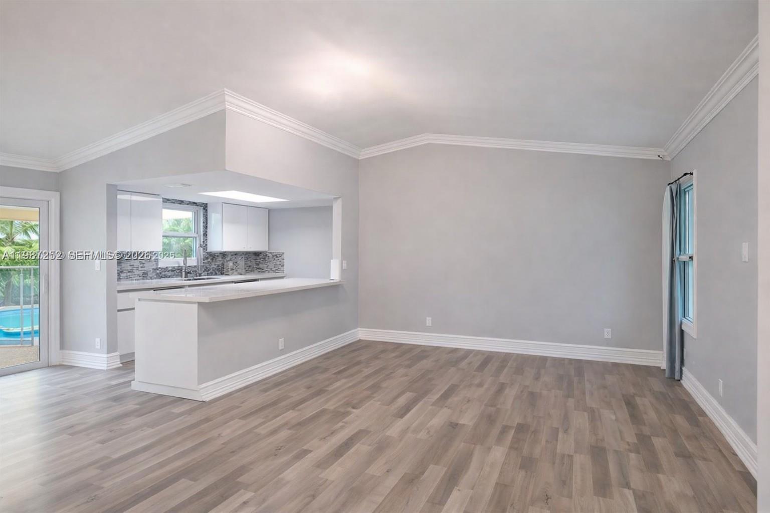 4541 Southwest 28th Terrace Dania Beach, FL 33312 - Photo 3 of 9 a kitchen with a refrigerator and window