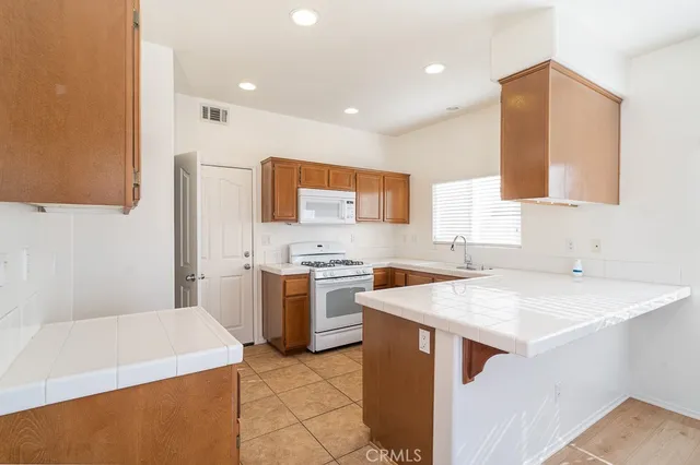 a kitchen with a sink stove and refrigerator