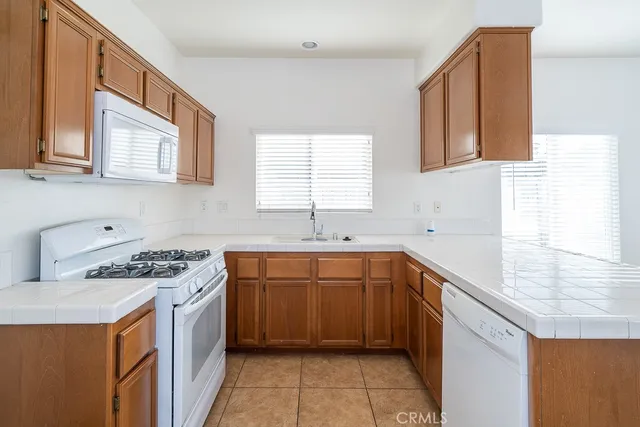 a kitchen with stainless steel appliances a sink stove and cabinets