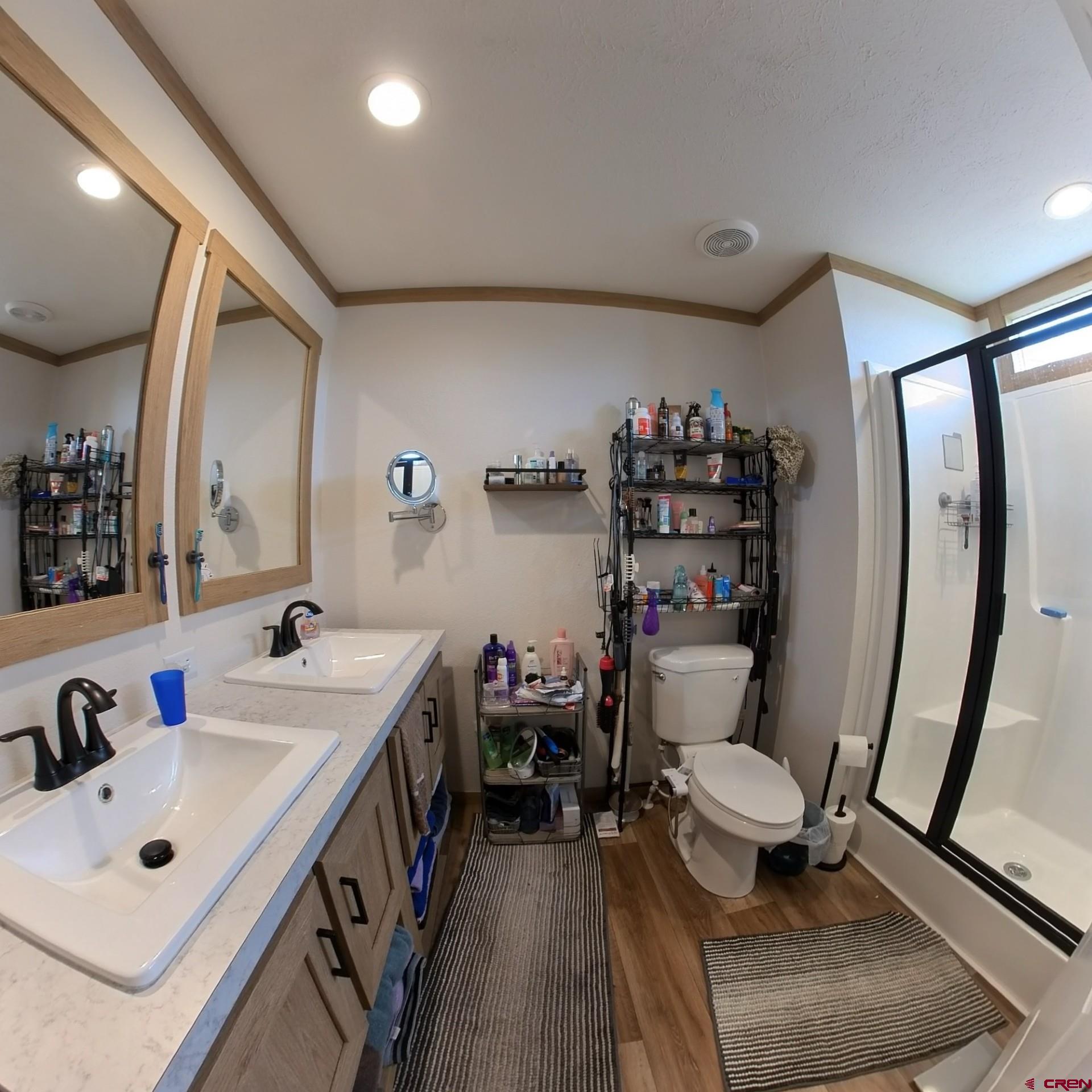 62650 Lasalle Road, Unit 822 Montrose, CO 81403 - Photo 13 of 17 a bathroom with a sink mirror vanity and toilet