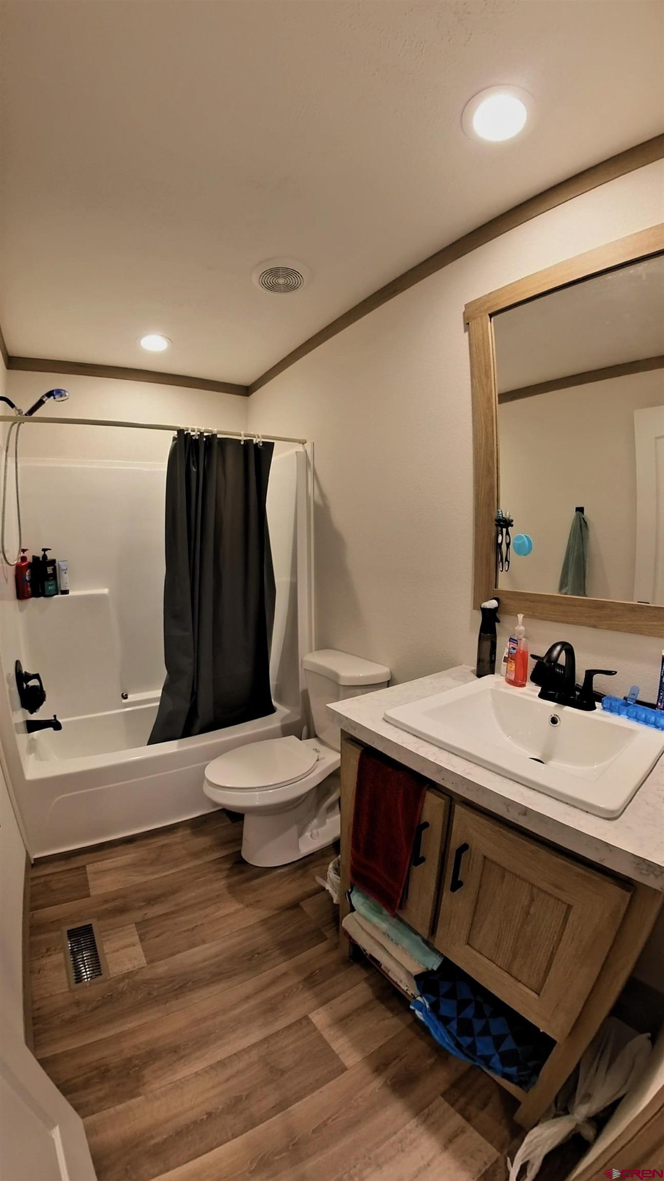 62650 Lasalle Road, Unit 822 Montrose, CO 81403 - Photo 15 of 17 a bathroom with a sink a toilet and shower