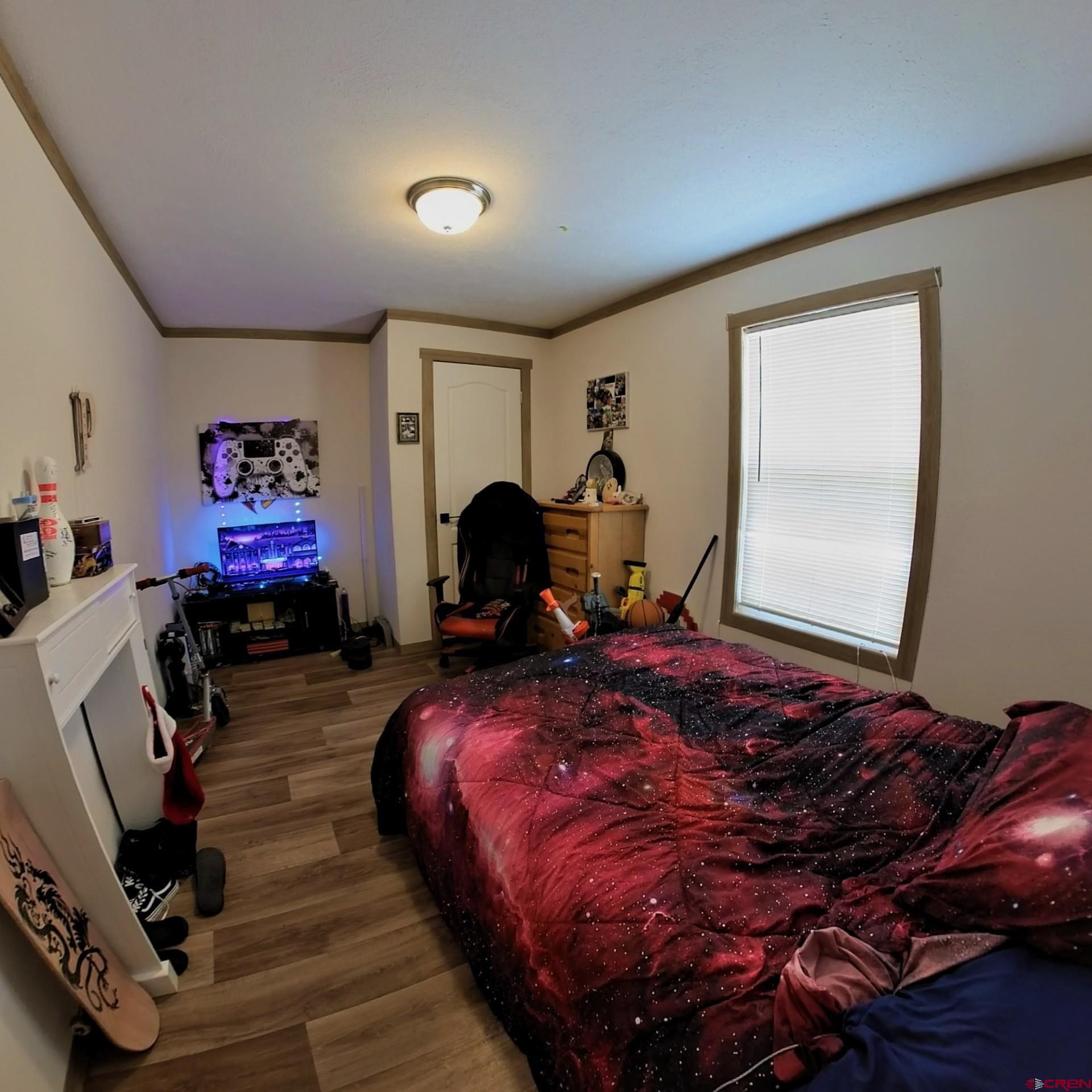 62650 Lasalle Road, Unit 822 Montrose, CO 81403 - Photo 16 of 17 a bedroom with bed and glass door