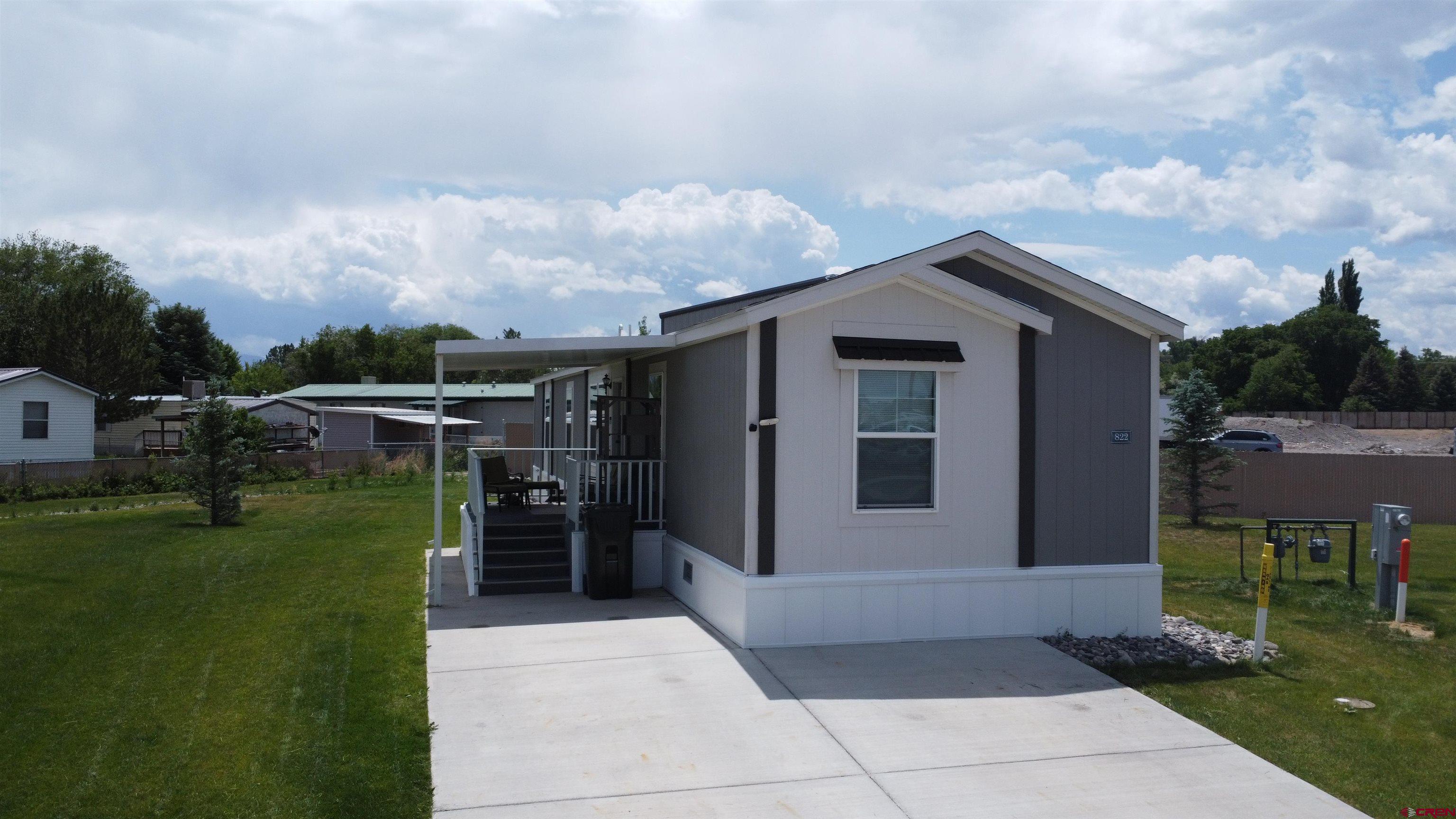 62650 Lasalle Road, Unit 822 Montrose, CO 81403 - Photo 17 of 17 a front view of a house with a garden