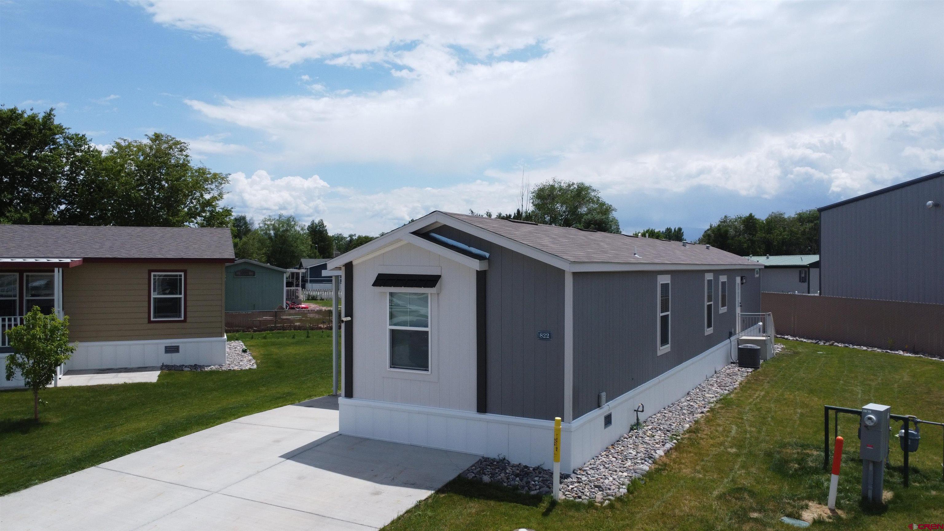 62650 Lasalle Road, Unit 822 Montrose, CO 81403 - Photo 3 of 17 front view of house with a yard