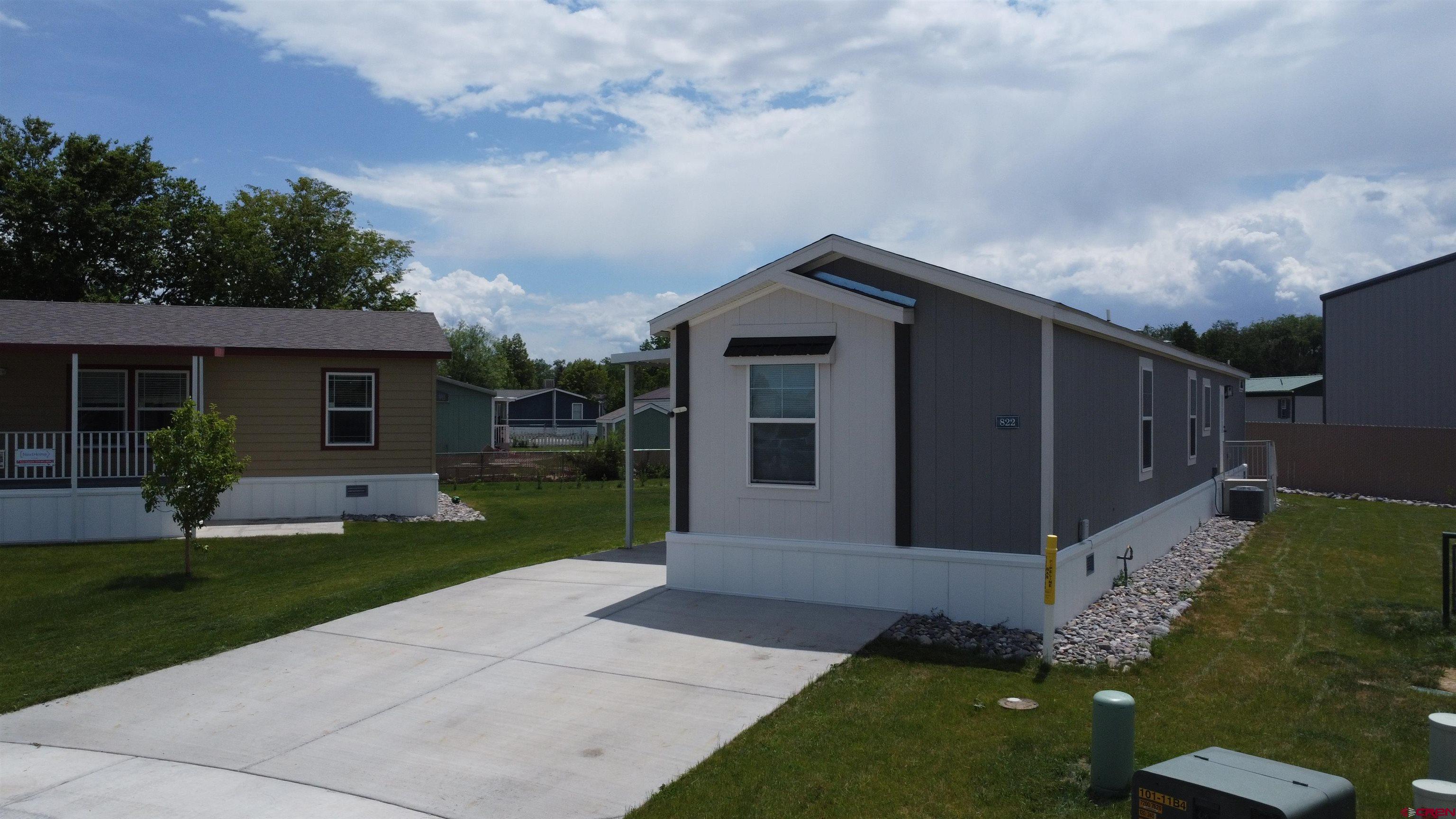 62650 Lasalle Road, Unit 822 Montrose, CO 81403 - Photo 4 of 17 a front view of house with a yard
