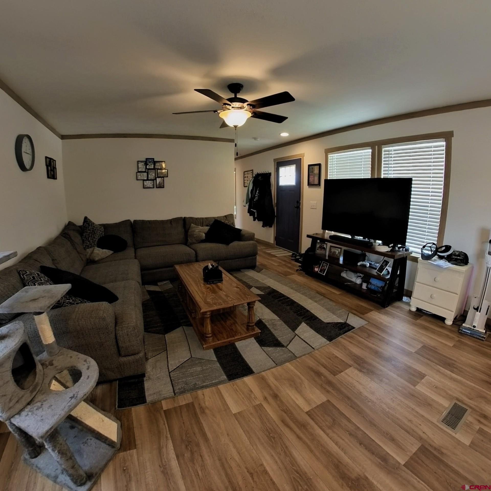 62650 Lasalle Road, Unit 822 Montrose, CO 81403 - Photo 6 of 17 a living room with furniture and a flat screen tv