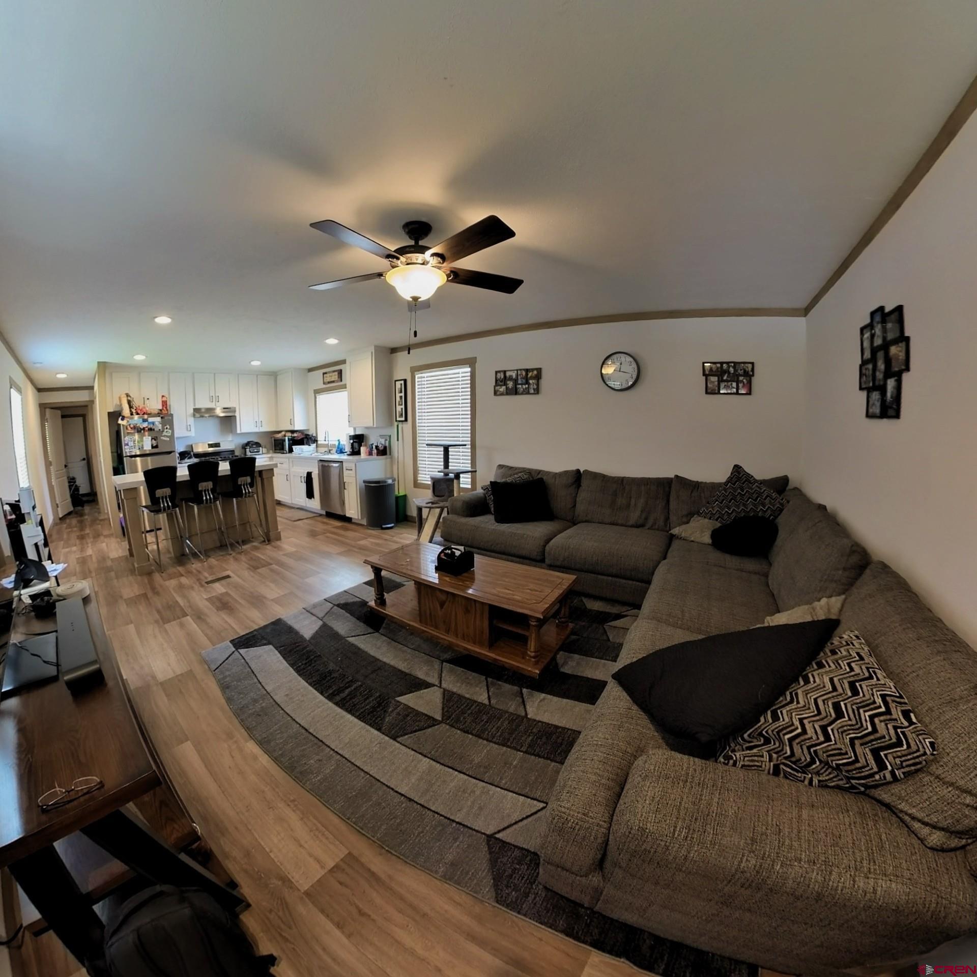 62650 Lasalle Road, Unit 822 Montrose, CO 81403 - Photo 8 of 17 a living room with furniture ceiling fan and a rug