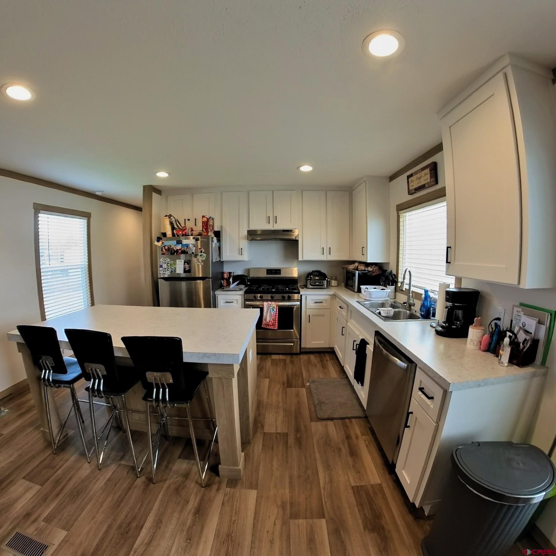 62650 Lasalle Road, Unit 822 Montrose, CO 81403 - Photo 9 of 17 a large kitchen with cabinets table and chairs