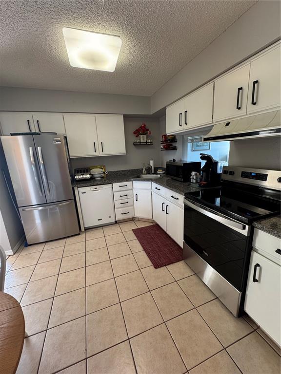 5567 Sea Forest Drive, Unit 319 New Port Richey, FL 34652 - Photo 14 of 34 a kitchen with stainless steel appliances a sink a stove a refrigerator and cabinets