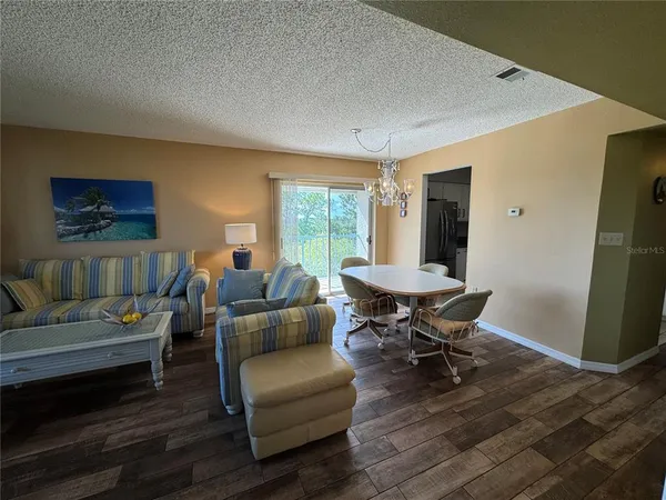 a living room with furniture rug and wooden floor