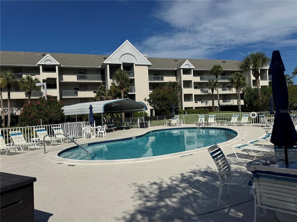 5567 Sea Forest Drive, Unit 319 New Port Richey, FL 34652 - Photo 2 of 34 a view of a swimming pool with chairs