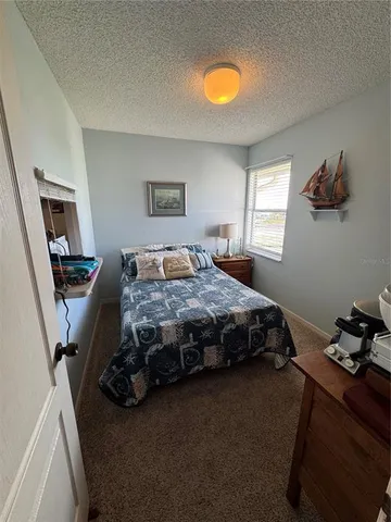a bedroom with two beds and painting on the wall
