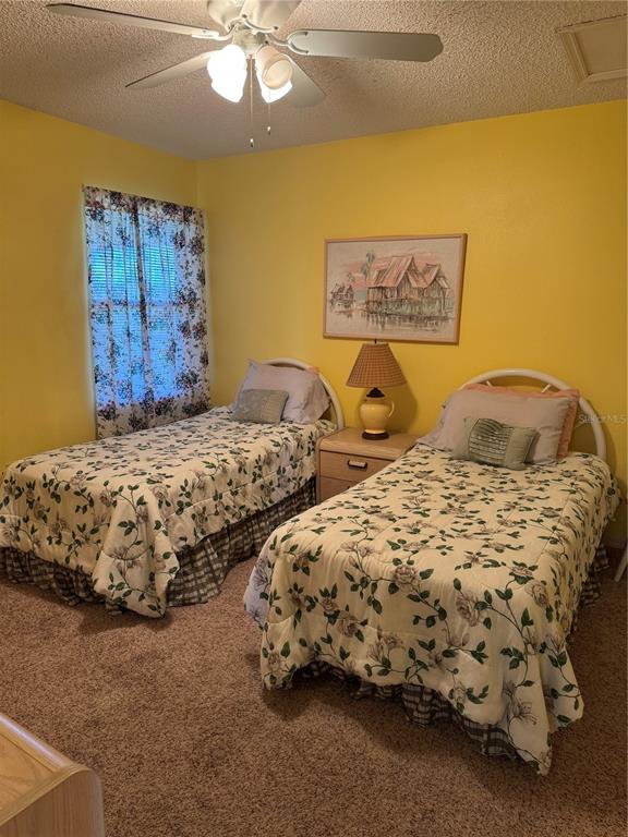 5567 Sea Forest Drive, Unit 319 New Port Richey, FL 34652 - Photo 33 of 34 a bedroom with two beds and painting on the wall